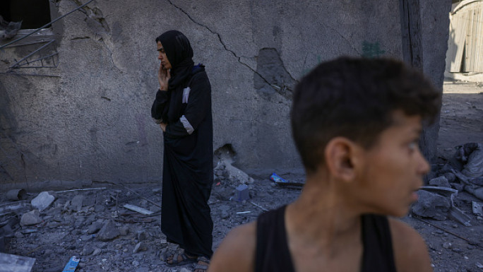 Poeple check the site of an overnight Israeli strike, in Jabalia in the central Gaza Strip, on May 30, 2025